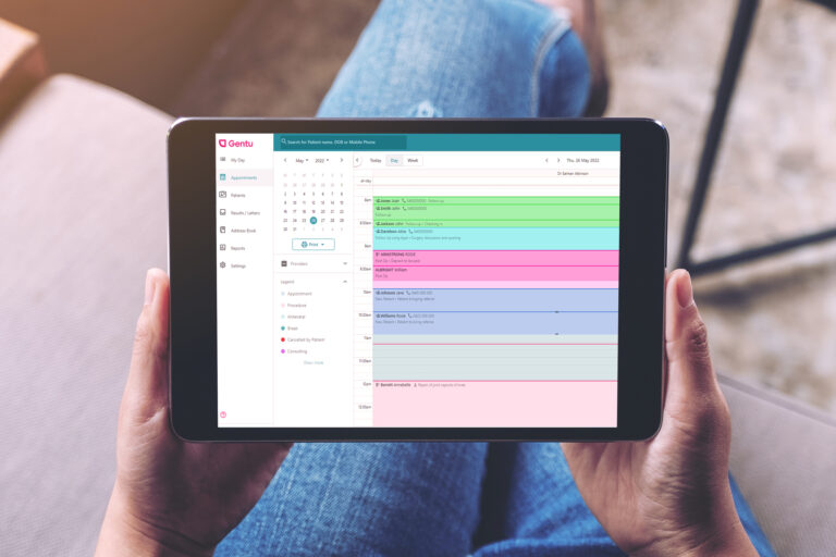 Practice manager holding ipad with Gentu practice management software on screen