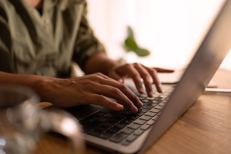 Woman typing on laptop computer